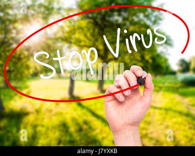 Man Hand writing Stop Virus with black marker on visual screen. Isolated on nature. Business, technology, internet concept. Stock Photo Stock Photo
