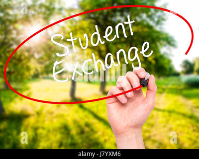 Man Hand writing  Student Exchange with black marker on visual screen. Isolated on background. Business, technology, internet concept. Stock Photo Stock Photo