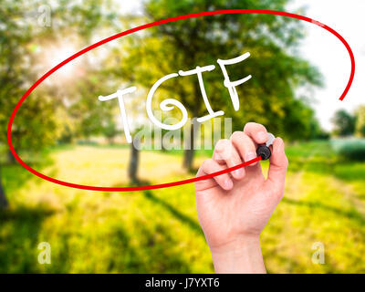 Man Hand writing TGIF with black marker on visual screen. Isolated on nature. Business, technology, internet concept. Stock Photo Stock Photo