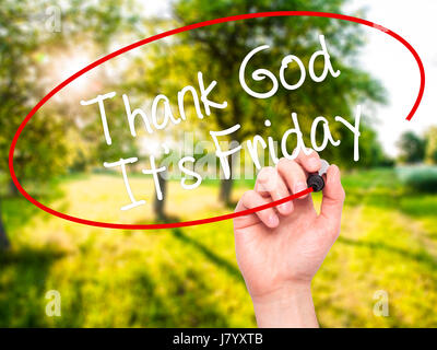 Man Hand writing Thank God It's Friday with black marker on visual screen. Isolated on nature. Business, technology, internet concept. Stock Photo Stock Photo