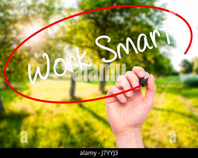 Man Hand writing Work Smart with black marker on visual screen. Isolated on nature. Business, technology, internet concept. Stock Photo Stock Photo