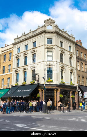 Crowd of people drinking outside The Ten Bells pub on Commercial Road in Spitalfileds, London, UK Stock Photo