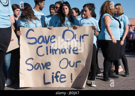 Young activists at the COP22 UN climate conference hold a sign reading 'Save Our Climate, Save Our Life' at a demonstration in Jemaa el-Fnaa, the central market plaza in Marrakech, Morocco, November 10, 2016.