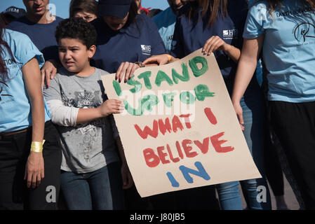 Young activists at the COP22 UN climate conference hold a sign reading 'I Stand Up For What I Believe In' at a demonstration in Jemaa el-Fnaa, the central market plaza in Marrakech, Morocco, November 10, 2016.