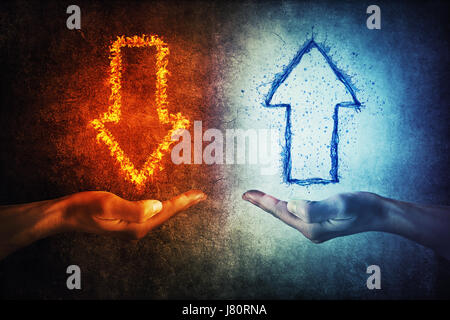 Two human hands holding flaming and splashing infographic arrows on a gray background. Business situation, growth and decline. Stock Photo