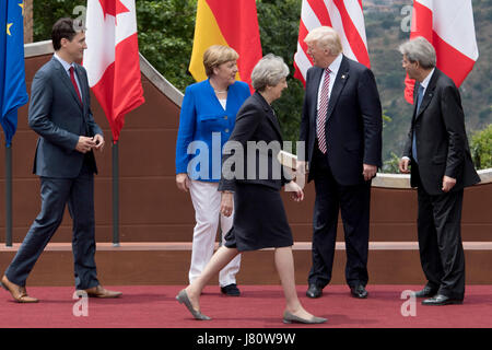 Prime Minister Theresa May walks past (from the left) Candian Prime Minister Justin Trudeau, German Chancellor Angela Merkel, US President Donald Trump and Italian Prime Minister Paolo Gentiloni as she arrives for the family photo at the G7 summit at Teatro Greco in Taormina, Sicily, Italy. Stock Photo