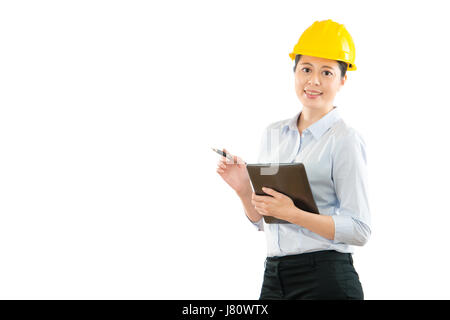asian chinese female contractor engineer with hat hand holding digital tablet computer and pen inspecting correct structure at construction site isola Stock Photo