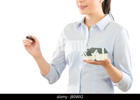 portrait of young beautiful famous designer drawing a project of building on the copyspace and showing stereoscopic illustration miniature house model Stock Photo