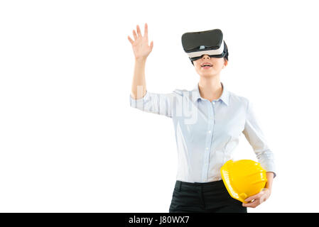 young woman using a virtual reality headset with architecture site work and hand gesture in the air while work on the copyspace at all blank white wal Stock Photo