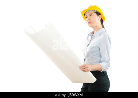 woman foreman opened design image examine actual building make sure correct on white wall and thinking on the copyspace, architect working on construc Stock Photo