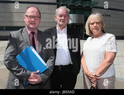 The only survivor of the Kingsmill massacre Alan Black (centre) along with solicitor Barry O'Donnell and Tania Smith, sister of massacre victim John McConville, outside Laganside courts in Belfast, as the inquest into IRA shooting dead of 10 Protestant workmen in South Armagh in 1976 continues. Stock Photo