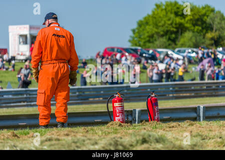 A Motorsport Marshal stationed at his post during the 2017 BTCC meeting at Thruxton. Stock Photo