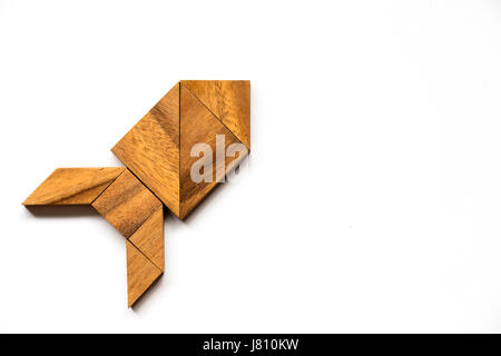 Wooden tangram puzzle in rocket shape on white background (Concept for new experience, start project) Stock Photo