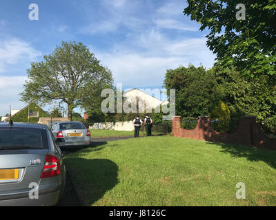 Editors note image pixelated by PA picture desk Police at the scene after two pensioners were found murdered in their home in Co Armagh. Stock Photo