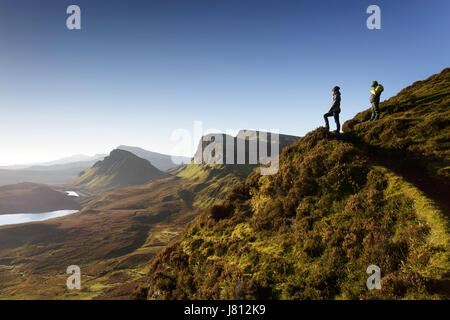 Mother and son standing on the plateau and looking at the dramatic landscape in Quiraing, Isle of Skye, Scotland. Stock Photo