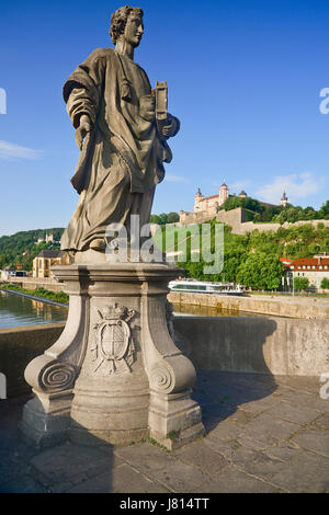 Germany, Bavaria, Wurzburg, Festung Marienberg above the River Main with a statue of St Totnan on Alte Mainbrucke. Stock Photo