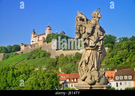 Germany, Bavaria, Wurzburg, Festung Marienberg above the River Main with a statue of St Marie or Mary Patron saint of Franconia. Stock Photo