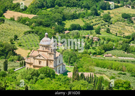 Italy, Tuscany, Montepulciano, Tempio di San Biagio Church. High Renaissance church with domed roof surrounded by lush green trees and olive groves. Stock Photo