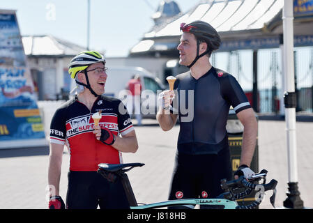 Brighton, UK. 26th May, 2017. Cyclists enjoy an ice cream in the beautiful sunshine on Brighton seafront this morning before setting off for London with today forecast to be the hottest day of the year so far with temperatures reaching the high 20s celsius in some parts of Britain Credit: Simon Dack/Alamy Live News Stock Photo