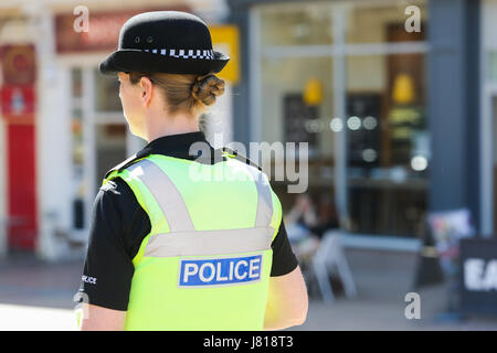 Uniformed UK female police officer in ready stance holding metal Stock ...