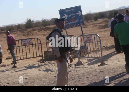 Cairo, Egypt. 26th May, 2017. Egyptian policemen block the road about 10 kilometers away from the attack site, in Minya Governorate, south of Cairo, Egypt, May 26, 2017. Gunmen opened fire on buses carrying Coptic Christians south of the Egyptian capital on Friday, killing 26 people and wounding 25, health ministry said. Credit: Ahmed Gomaa/Xinhua/Alamy Live News Stock Photo