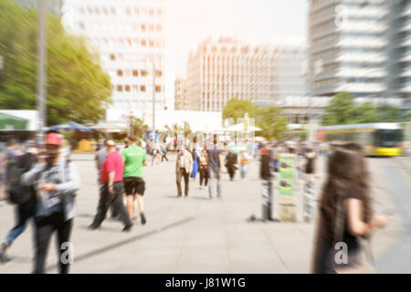 picture with motion blur of a crowd of people crossing a city street at the pedestrian zone Stock Photo