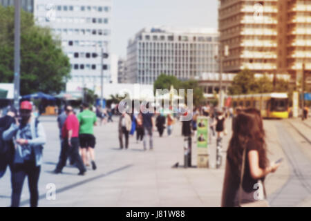 crowds of people in motion blur crossing a city street Stock Photo