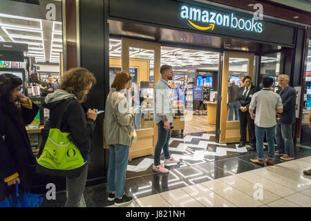 Customers wait to enter in the new Amazon Books in the Time Warner Center in New York on opening day, Thursday, May 25, 2017.  The 4000 square foot store is the company's seventh store and its first in New York City. The store has a limited amount of books curated by data compiled on purchases made by customers on Amazon. Another store in midtown is scheduled to open later this year. (© Richard B. Levine) Stock Photo