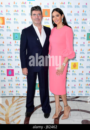 Simon Cowell and Lauren Silverman attending the Simon Cowell and The Dorchester treat children supported by Shooting Star Chase children's hospice to Afternoon Tea, London. Stock Photo