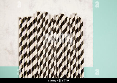 numerous straw on marble and turquoise color background Stock Photo