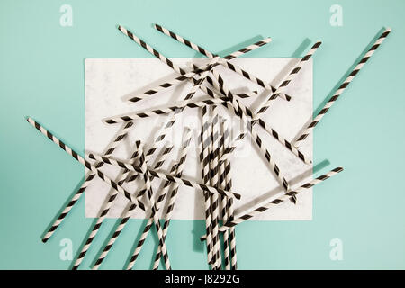 numerous straw on marble and turquoise color background Stock Photo