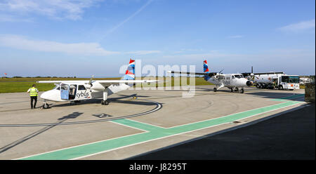 A Britten-Norman BN-2 Islander and a De Havilland DHC-6-300 Twin Otter Isles of Scilly Skybus aeroplanes or aircraft at Lands End airport Stock Photo