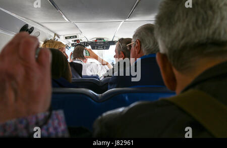 Passengers on a Britten-Norman BN-2 Islander Isles of Scilly Skybus aeroplane or aircraft shuttle service between Lands End and the Isles of Scilly Stock Photo