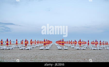 ALBENA, BULGARIA - JUNE 13, 2016. The Black Sea shore. blue sea water, clouds sunset sky, beach sand with umbrellas and sunbeds Stock Photo