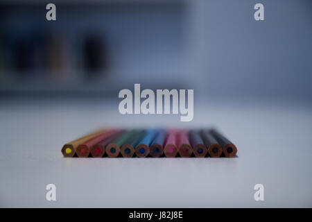 Colorful crayons on a white table Stock Photo