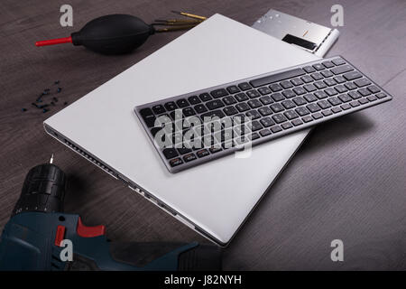 computer notebook with coponent and tool (repair concept) on wood table background Stock Photo
