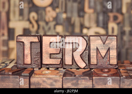 TERM word made from wooden letterpress blocks on many different letters background Stock Photo