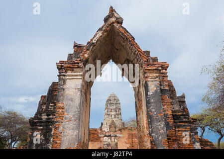 Ruins of buddha statues and pagoda of Wat Ratcha Burana temple in Ayutthaya historical park, Thailand Stock Photo