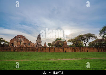 Ruins of buddha statues and pagoda of Wat Ratcha Burana temple in Ayutthaya historical park, Thailand Stock Photo