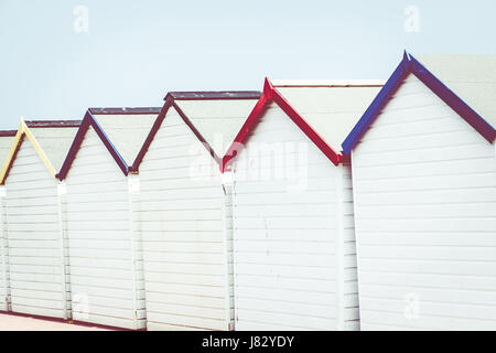 A row of colourful beach huts at Preston Green seafront, Devon.  May 2017 Stock Photo