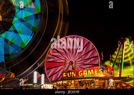 Evergreen State Fair with ferris wheel and game booths at night Stock Photo