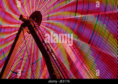 Ferris wheel in motion with multi colors and abstract patterns of colors Stock Photo