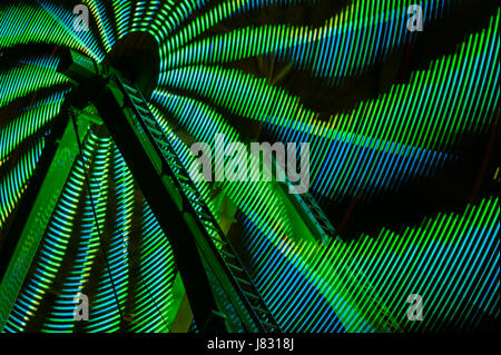 Ferris wheel in motion with multi colors and abstract patterns of colors Stock Photo