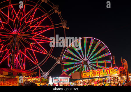 Evergreen State Fair with ferris wheel and game booths at night Stock Photo