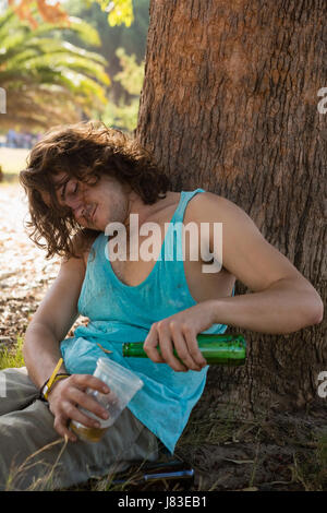 Unconscious drunken man having beer in the park Stock Photo - Alamy