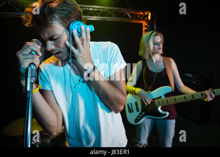Band performing on stage in nightclub Stock Photo