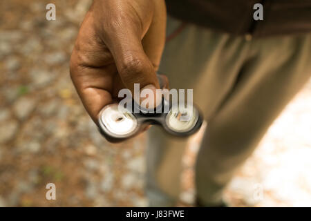 Close-up of a man hand s holding a fidget spinner Stock Photo