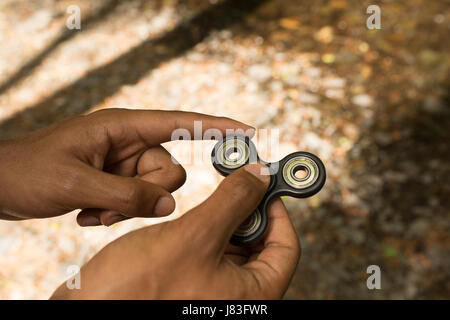Close-up of man hand s holding a fidget spinner Stock Photo