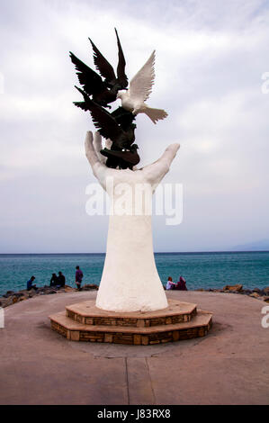 Unidentified Turkish people relax around the Hand Of Peace Monument in Kusadasi, Aegean Coast, Turkey Stock Photo