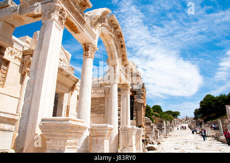 Izmir, Turkey - May 10, 2017: Hadrian's temple ruins with tourists walking around in anceint city of Ephesus on sunny day Stock Photo